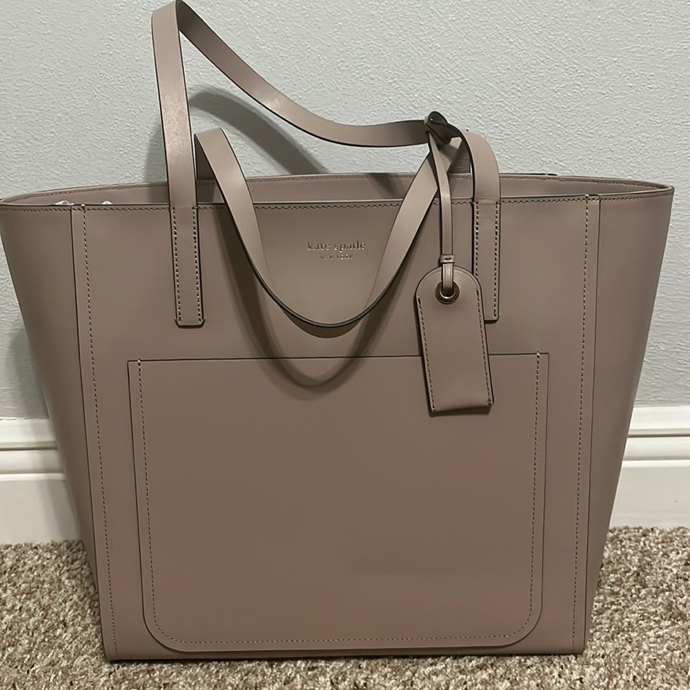 Kate Spade large pocket tote in muted taup. Never worn & has original tags.